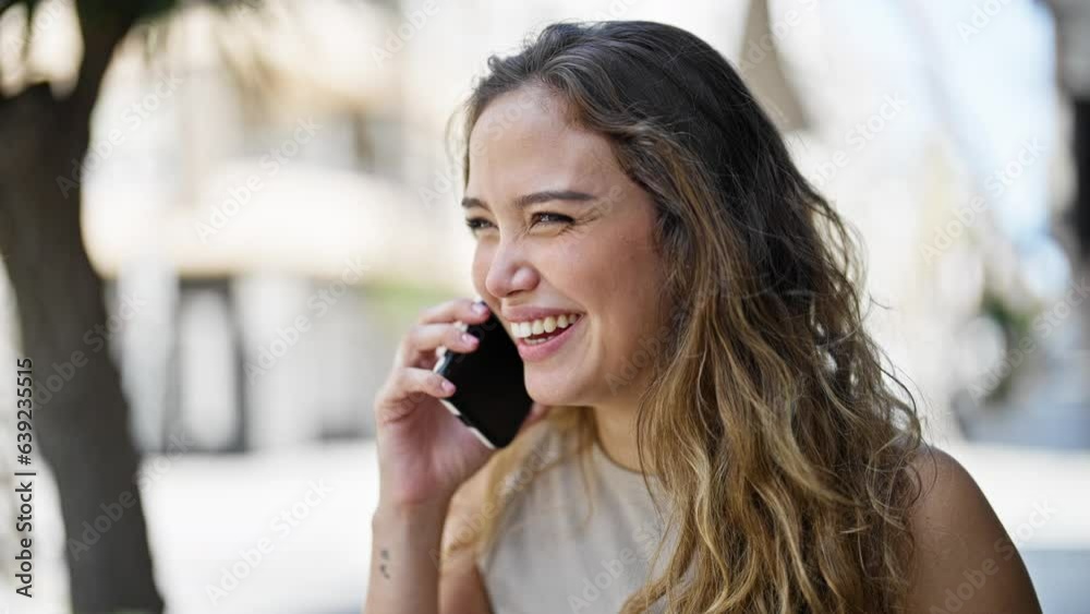 Young beautiful hispanic woman talking on the smartphone looking watch at street Young beautiful hispanic woman talking on the smartphone looking watch at street