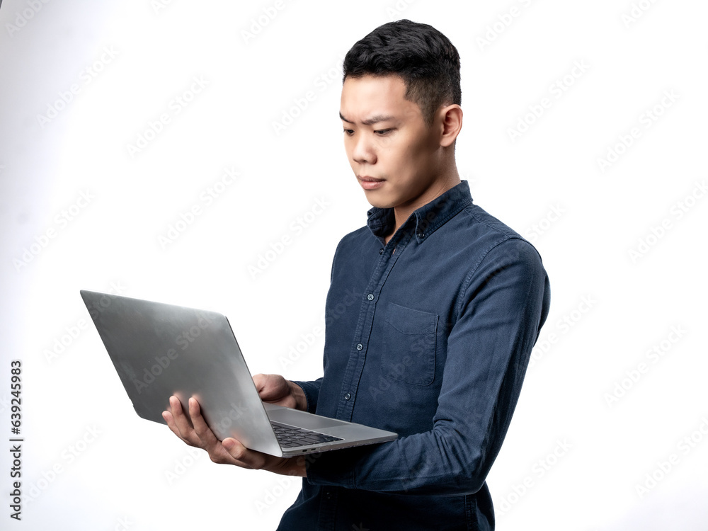 A portrait of an Asian man wearing a blue shirt, working while carrying a laptop, isolated with a white background.