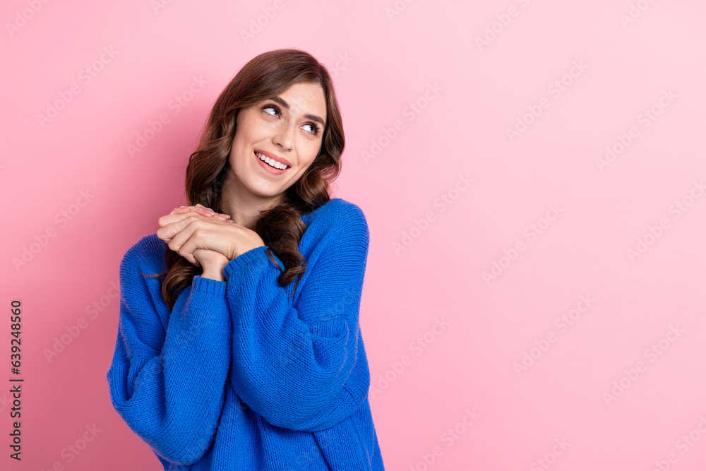 Photo portrait of lovely young lady hold arms together admire look empty space wear trendy blue garment isolated on pink color background Photo portrait of lovely young lady hold arms together admire look empty space wear trendy blue garment isolated on pink color background