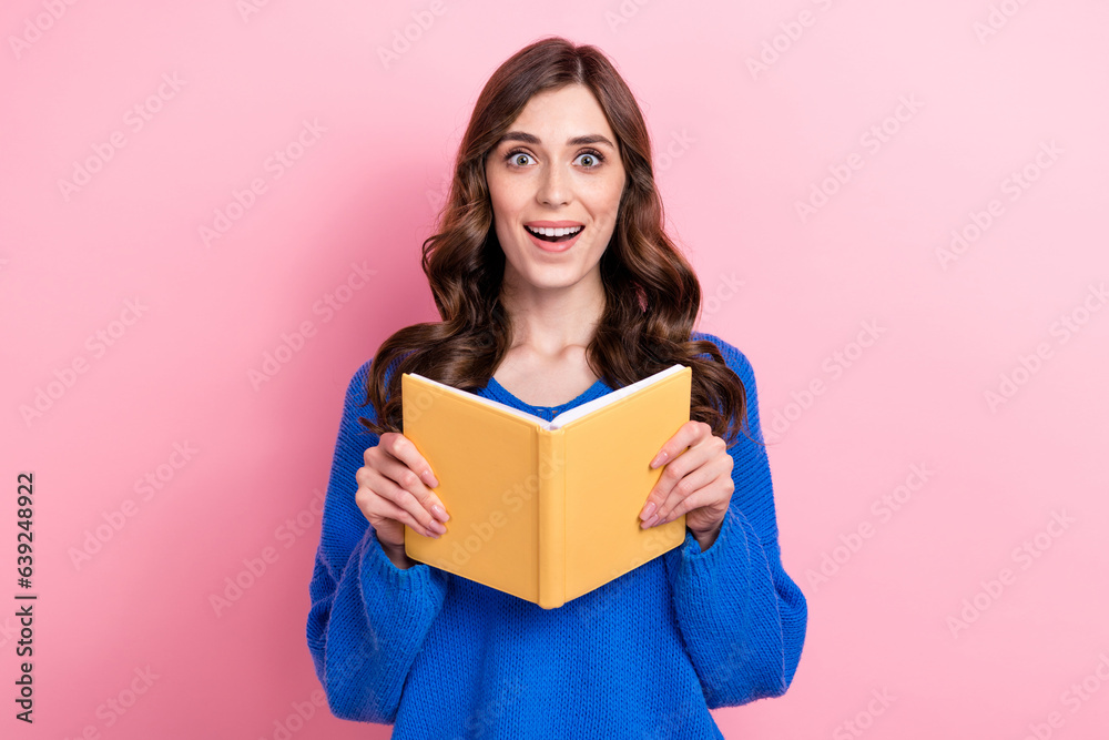 Photo portrait of attractive young woman hold read book impressed bookworm wear trendy blue clothes isolated on pink color background Photo portrait of attractive young woman hold read book impressed bookworm wear trendy blue clothes isolated on pink color background