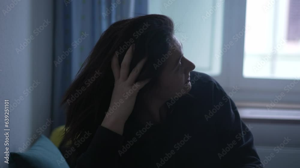 Pensive woman contemplating decision with hand in chin. Thoughtful person ponders life in bedroom at home Pensive woman contemplating decision with hand in chin. Thoughtful person ponders life in bedroom at home
