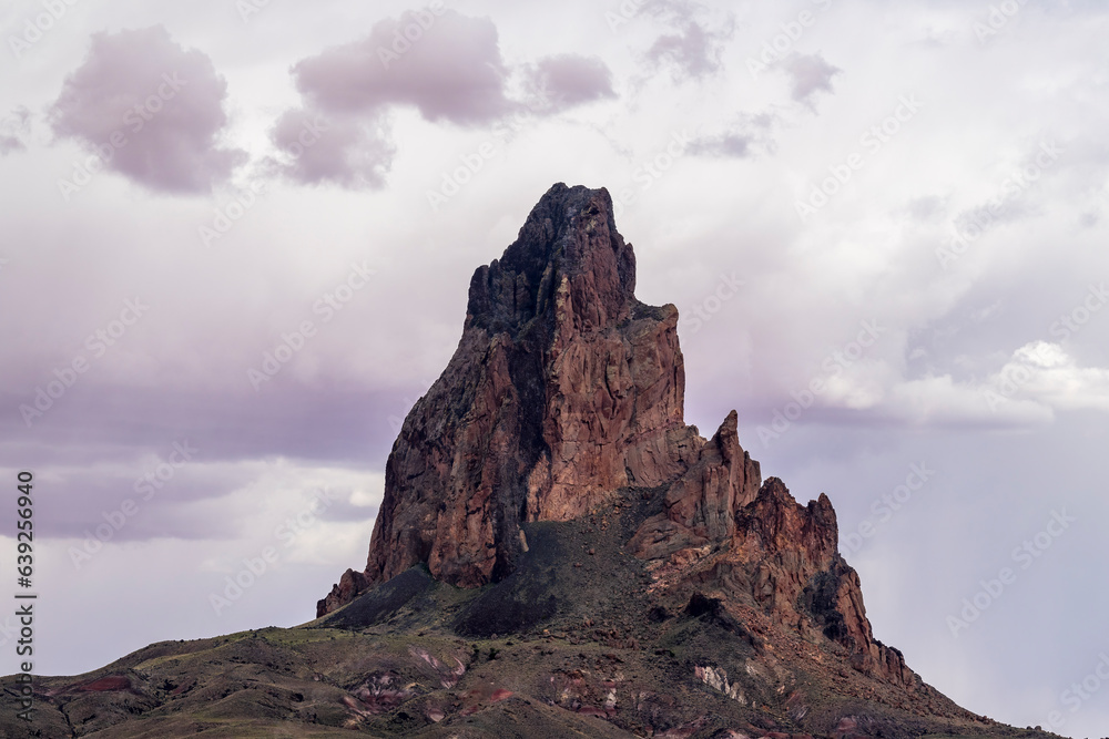 The rugged peaks Agathla Peak towering over the desert landscape south of Monument Valley along Highway US Route 163 in northern Arizona, United States
