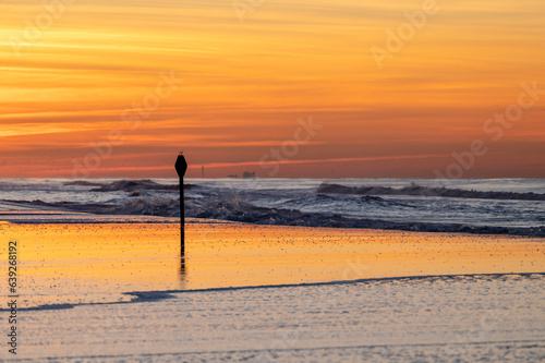 Colorful ocean with sunset vivid colors, North Sea with a boat on the background