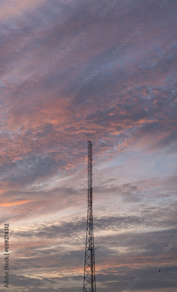 A truly majestic sunset sky with red clouds. The twilight sky with crimson clouds like a storm.