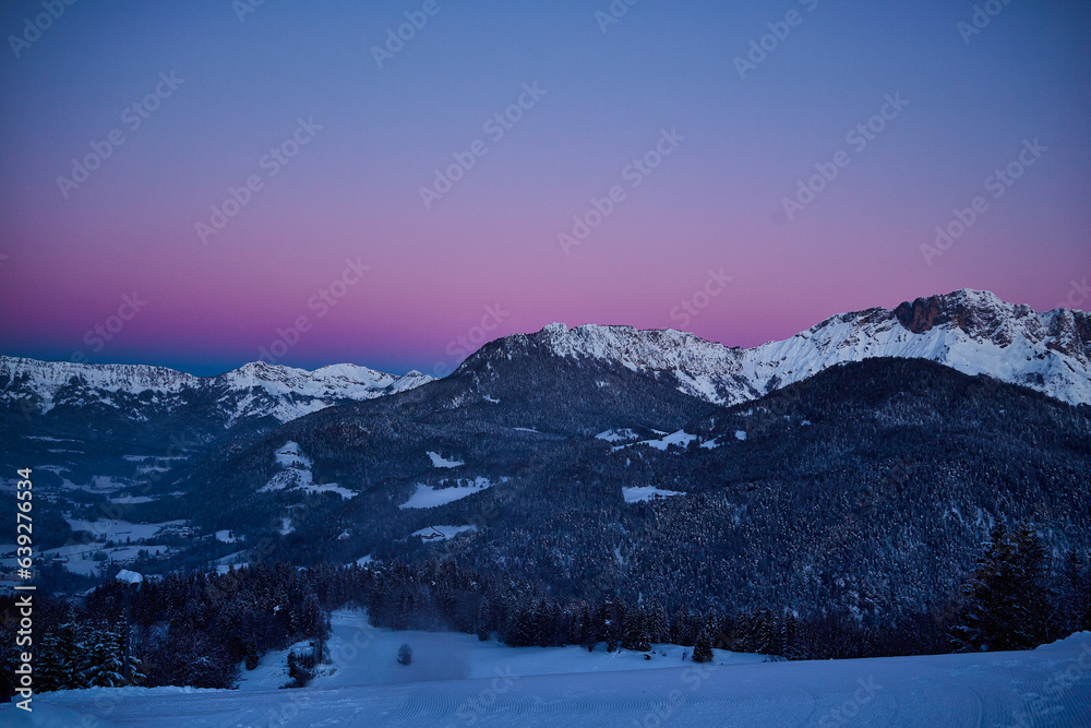 winter landscape in the mountains with snow covered trees, before sunrise