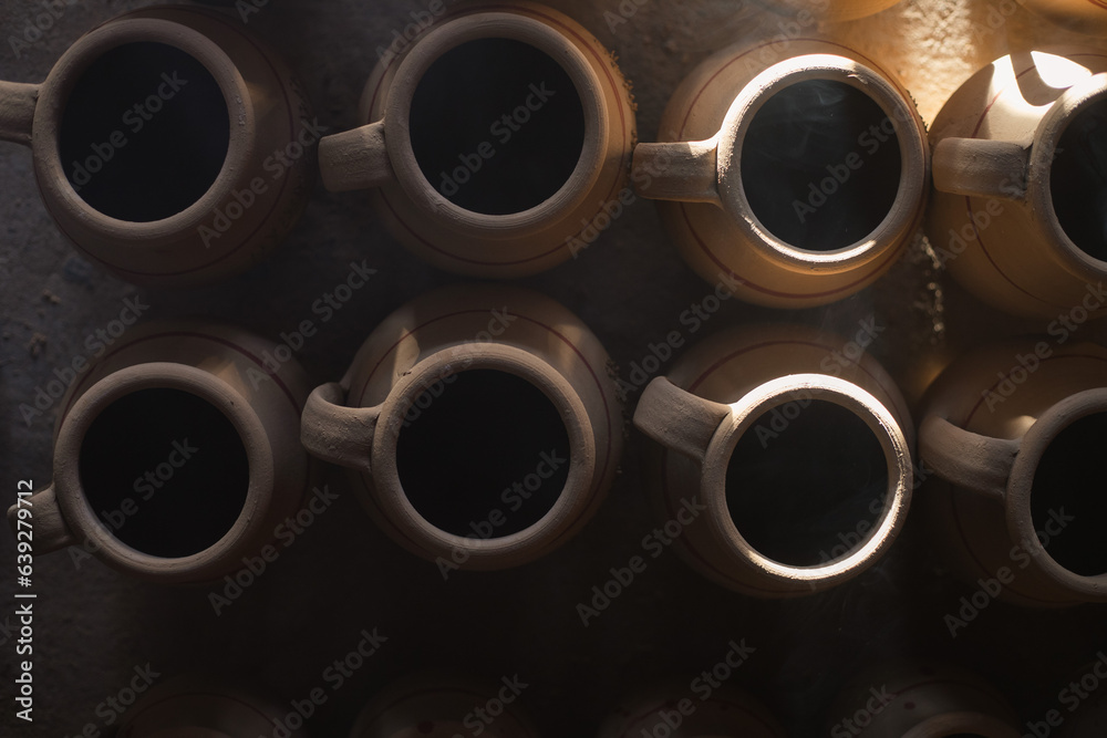 clay pots. Dark photography. Rays of light in the workshop clay pots. Dark photography. Rays of light in the workshop