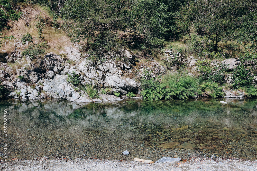 Mountain river near the village of Aquabianca in Italy, with clear water Mountain river near the village of Aquabianca in Italy, with clear water
