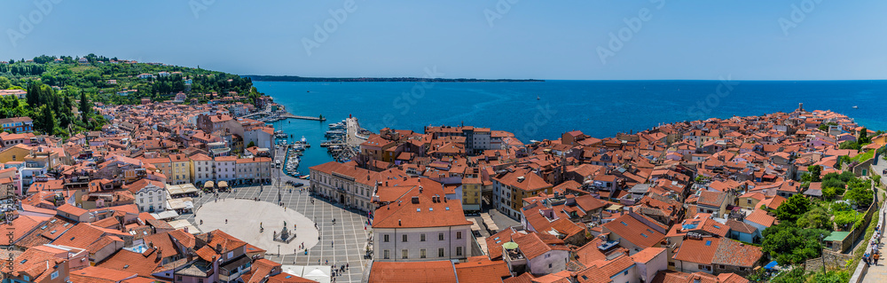 A panorama view down over the Central Square and promontory from the cathedral tower in the town of Piran, Slovenia in summertime