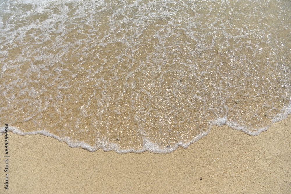 Abstract sandy beach and soft wave background Concept of traveling in Thailand, Phuket Abstract sandy beach and soft wave background Concept of traveling in Thailand, Phuket