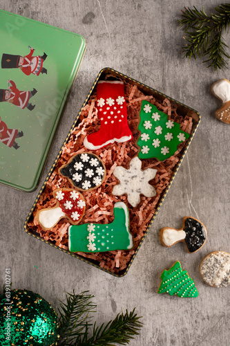 Christmas decorated shortbread cookies in a tin box. Holiday, celebration and cooking concept. Christmas vibes. Happy New Year.