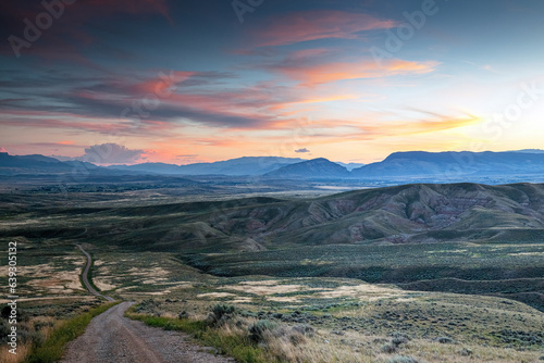 Dirt road down to the Bighorn Basin and foothills of Cody Wyoming at dusk.