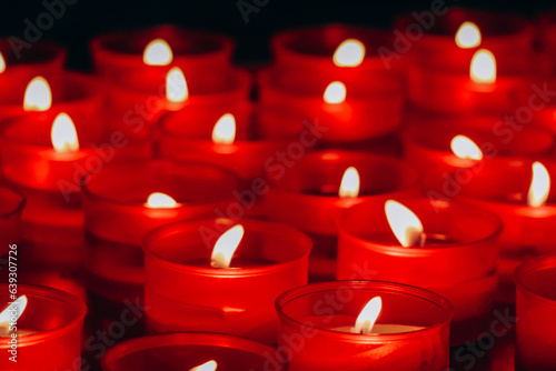 Close-up of red candles in the cathedral of the city of Como in Italy
