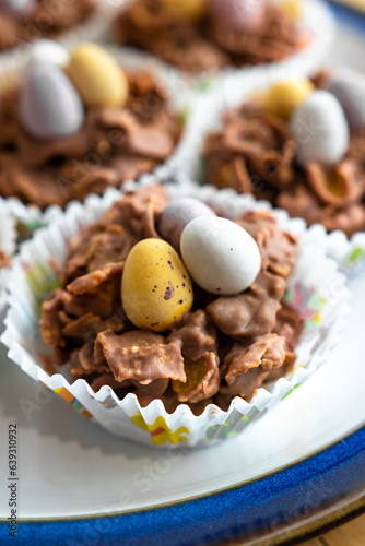 Chocolate pastries shaped like baskets with eggs  packaged in paper  rest on a plate