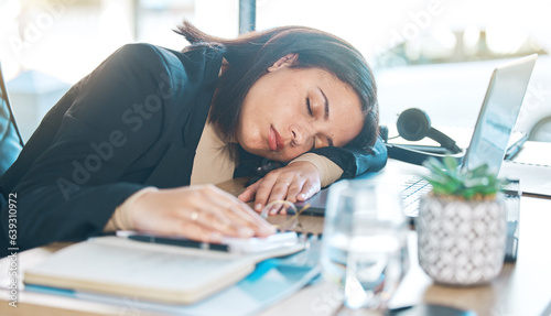 Tired, work and a woman at a desk for sleeping, corporate or working burnout in an office. Narcolepsy, table and a female business employee with a nap, rest or fatigue from company stress or job photo