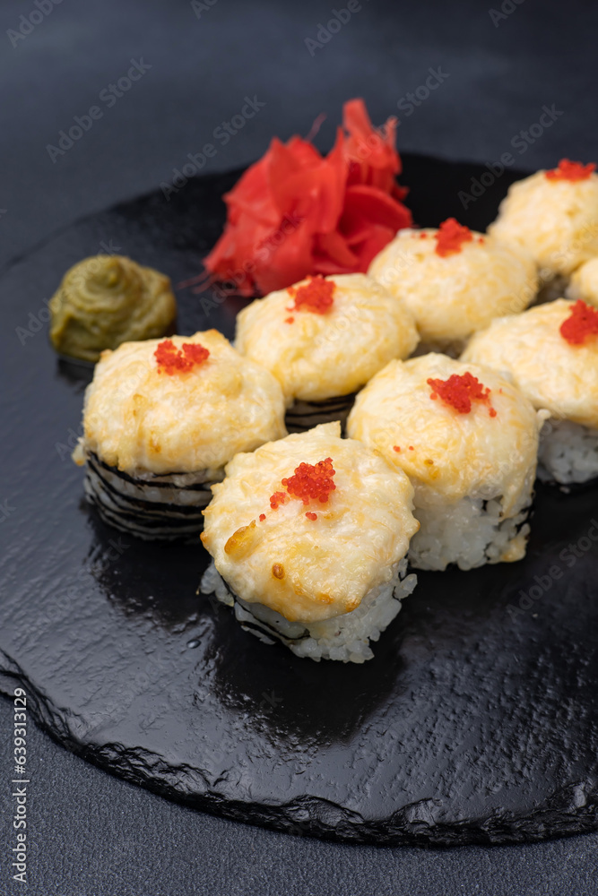 Delicious rolls on a dark background. Japanese cuisine. Close up Delicious rolls on a dark background. Japanese cuisine. Close up