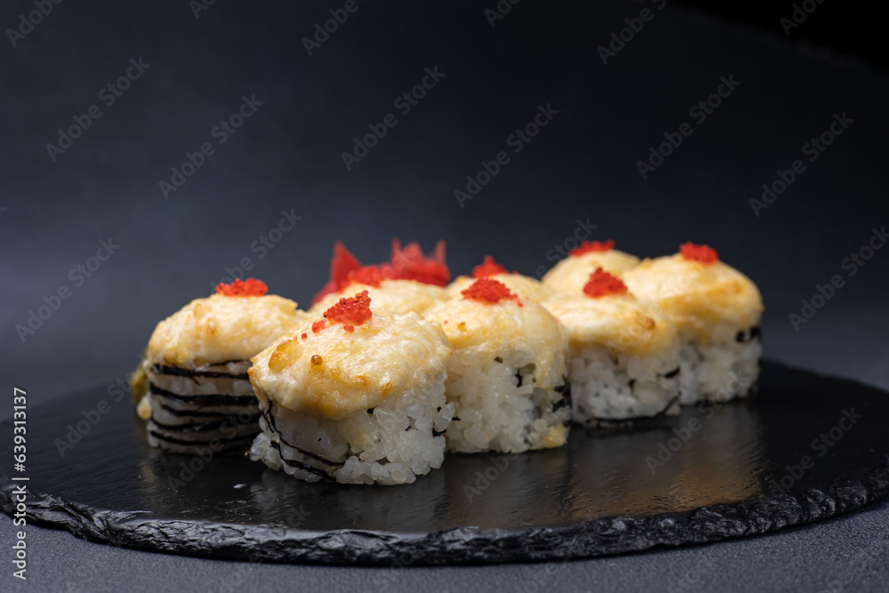 Delicious rolls on a dark background. Japanese cuisine. Close up Delicious rolls on a dark background. Japanese cuisine. Close up