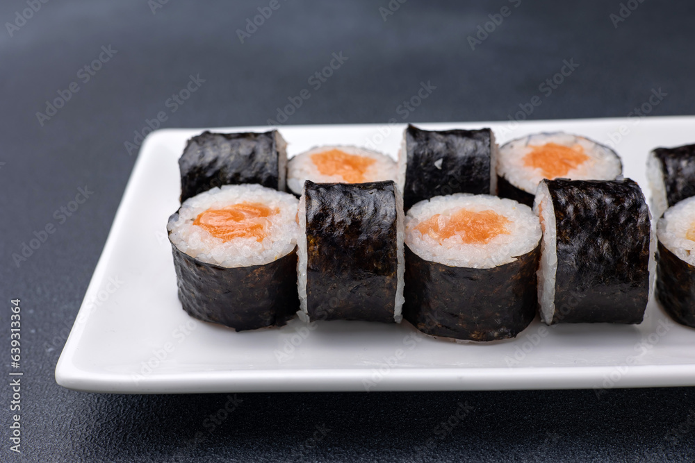 Delicious rolls on a dark background. Japanese cuisine. Close up Delicious rolls on a dark background. Japanese cuisine. Close up