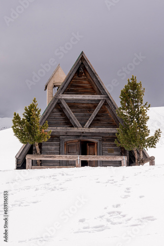 Old wooden chapel at Dolomity alps in Italy photo
