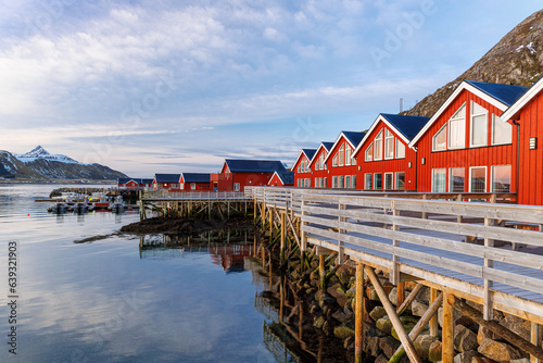 red houses on the shore of the sea at sunrise in leknes lofoten norway photo