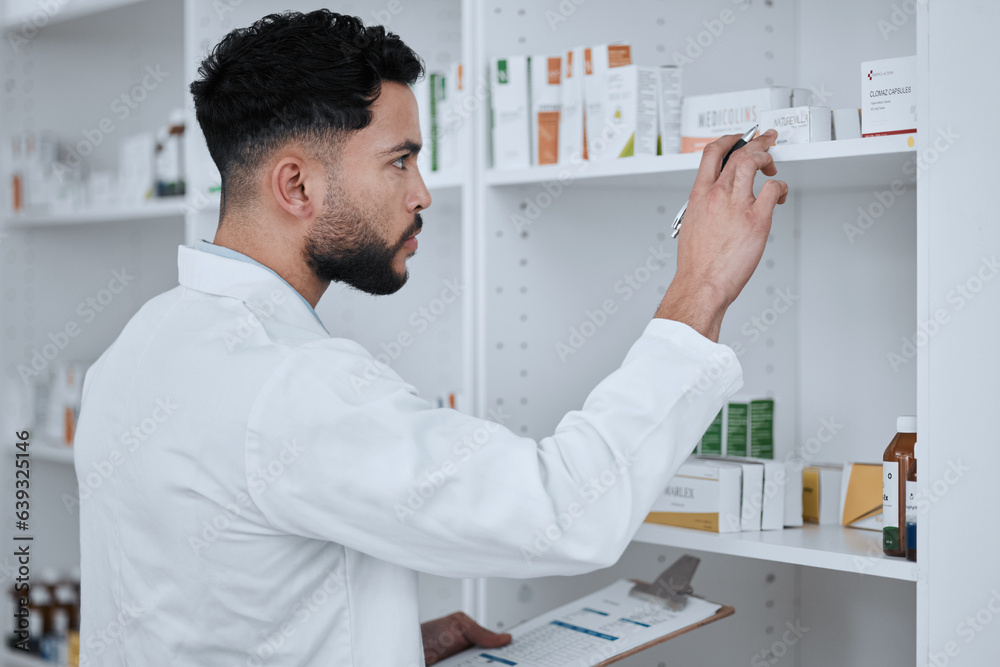 Man, pharmacist and inventory inspection on shelf in checking stock, medication or pills at pharmacy. Male person, medical or healthcare professional reading pharmaceutical product, drug or checklist