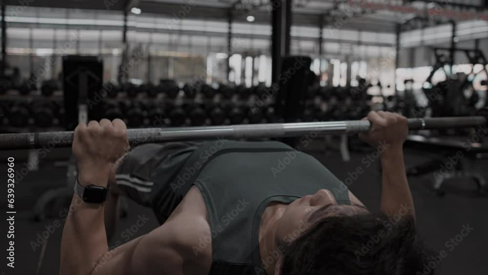 Man Lifting Weights at the Gym, Powerful Arm Muscle Workout for Bodybuilders, Building Stronger and Bigger Arm Muscles, Determined Young Man's Gym Routine.
