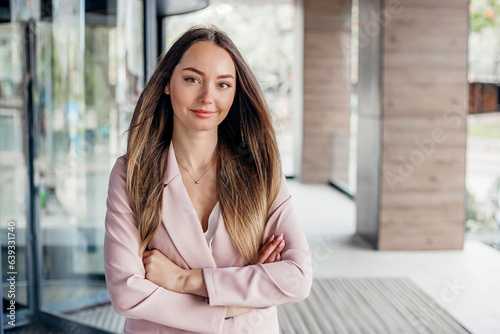 Free Download business woman with folded hands on the background of an office building - GFXLoad