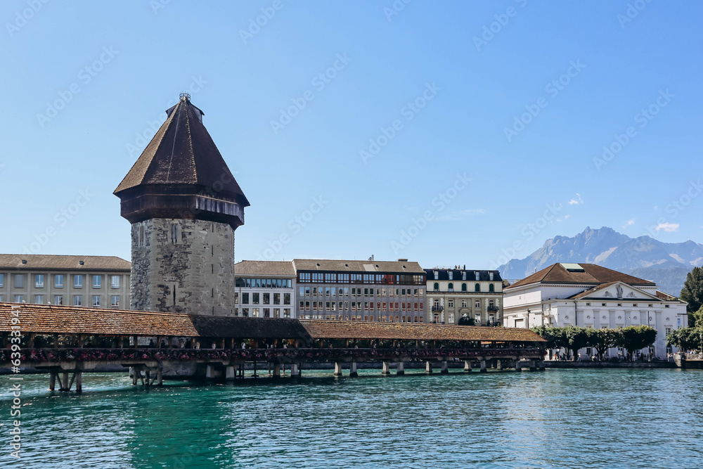 The Kapellbrucke (literally, Chapel Bridge), a covered wooden footbridge spanning the river Reuss diagonally in the city of Lucerne in central Switzerland