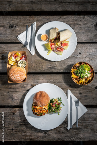A meal set for a hearty lunch for two at an Italian café - burgers, appetizer, French fries