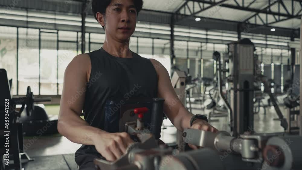 Man Bodybuilder Pulls Weight Machine, Building Forearm Strength, Bodybuilders Intense Gym Workout with Weight Machine. Man Bodybuilder Pulls Weight Machine, Building Forearm Strength, Bodybuilders Intense Gym Workout with Weight Machine.