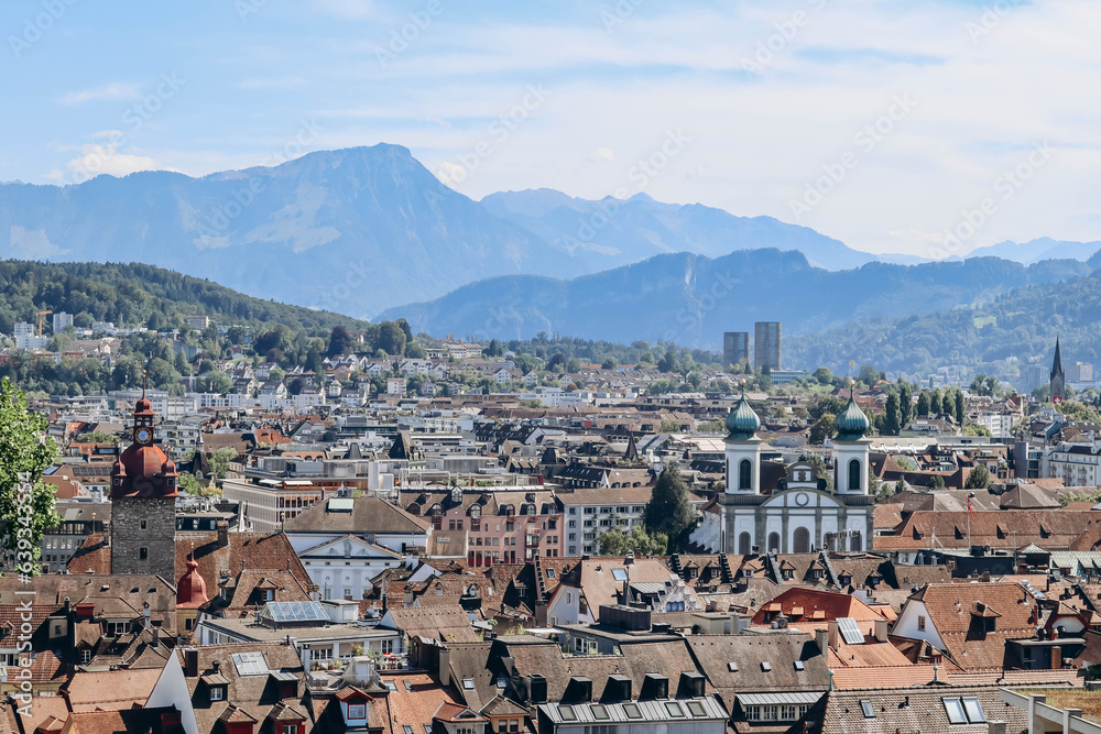 View of Lucerne rooftops, Lake Lucerne (Lake of the four forested settlements) and the Alps in the background