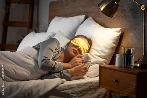 Young woman with mask sleep...