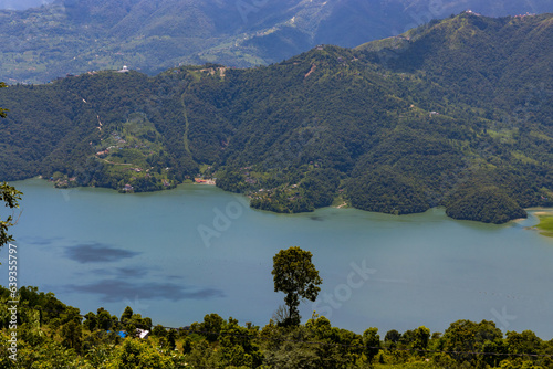 Beautiful Green Phewa Lake with Boats and Green Mountains in Pokhara City of Nepal during monsoon