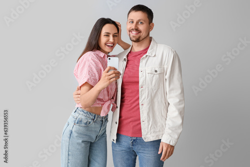 Happy young couple with mob...