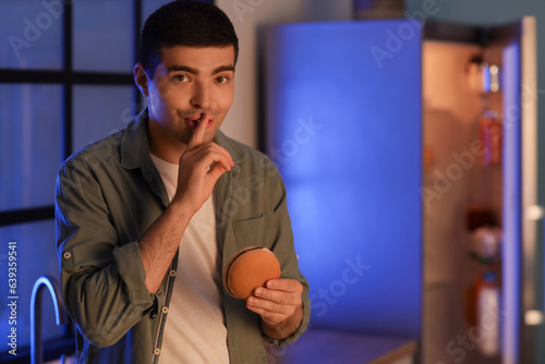 Hungry young man with burge...