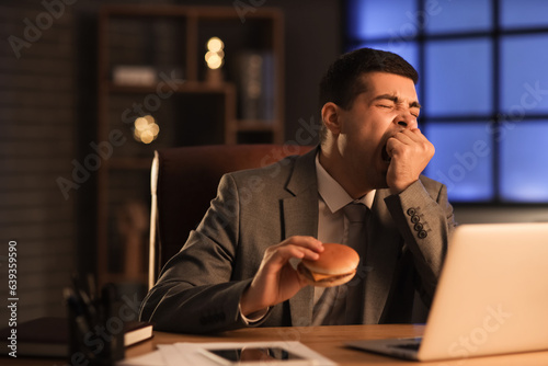 Sleepy young businessman wi...