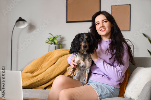 Young woman with cute cocker spaniel at home
