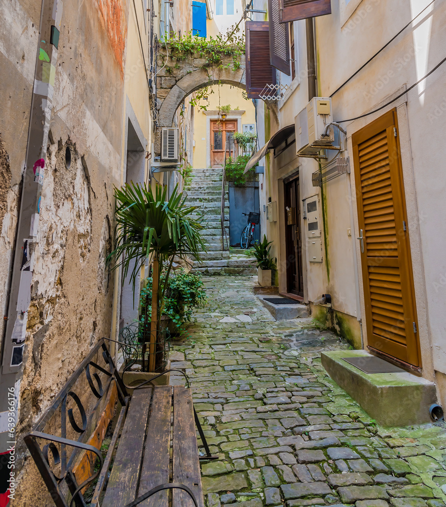 A view up a quiet backstreet in the old quarter of the town of Piran, Slovenia in summertime