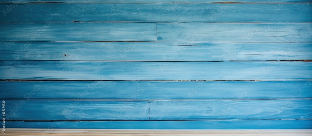 Room with a light colored wooden wall and a blue background