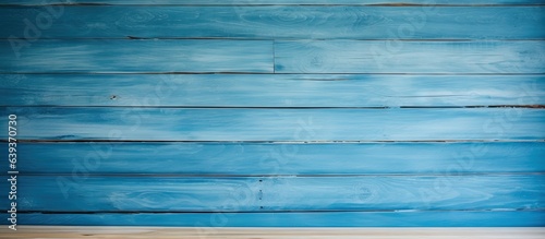 Room with a light colored wooden wall and a blue background