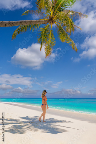 Beautiful carefree woman bikini suntan sunbathing, ocean tropical coast. Palm tree shadow on closeup sandy beach. Travel vacation paradise panoramic banner blue sea sky. Happy leisure summer lifestyle