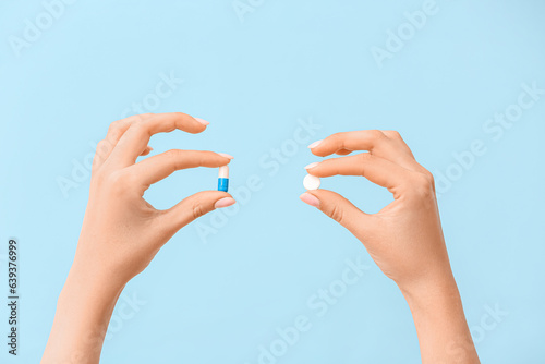 Woman holding different pil...