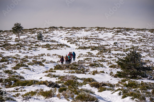 Mountain hikers in winter at the Sierra de Guadarrama National Park in Madrid, Spain.  photo