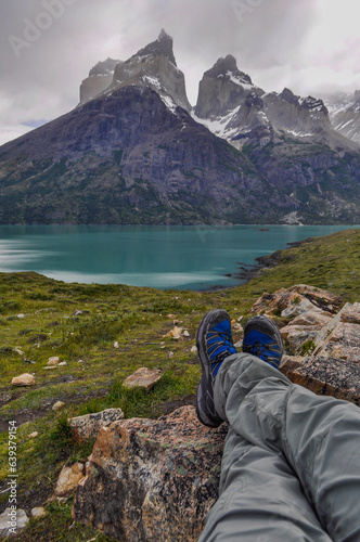 Person contemplating the Torres del Paine Mountains at la Patagonia in Chile. Southamerica. photo
