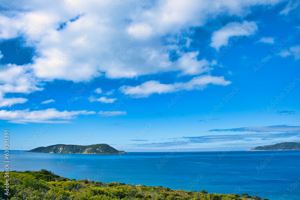 Michaelmas Island at the mouth of Frenchman Bay, Albany, Western Australia. Rocky island in a vast blue sea.
