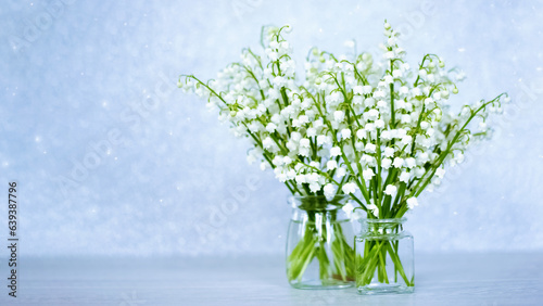two bouquets of lilies of the valley close-up. festive background with bouquets of forest lilies of the valley.