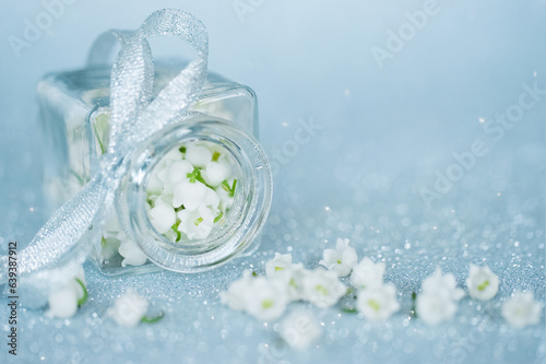 background with lily of the valley flowers. lilies of the valley in a vase and a copy of the space. a holiday card with lily of the valley flowers.