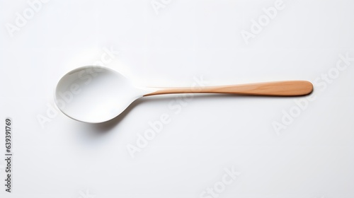 small and simple spoon on a table, white background