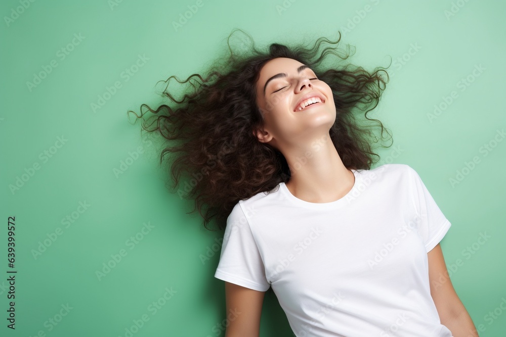 female lying down on back wearing white tshirt on green background for mock up female lying down on back wearing white tshirt on green background for mock up