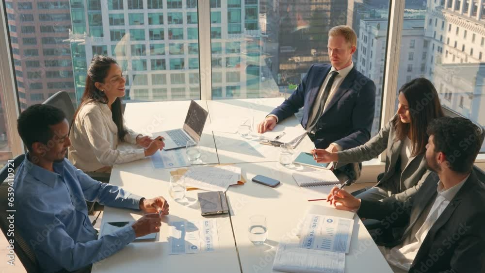 Multiethnic professional busy employees and executives board team people at group meeting discussing work results managing company project plan working together in modern board room office.