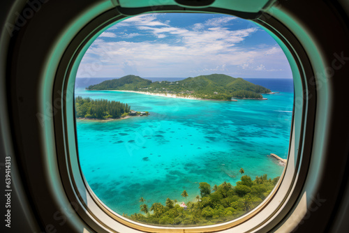 Tropical island with turquoise water aerial view through an aircraft window © Guido Amrein